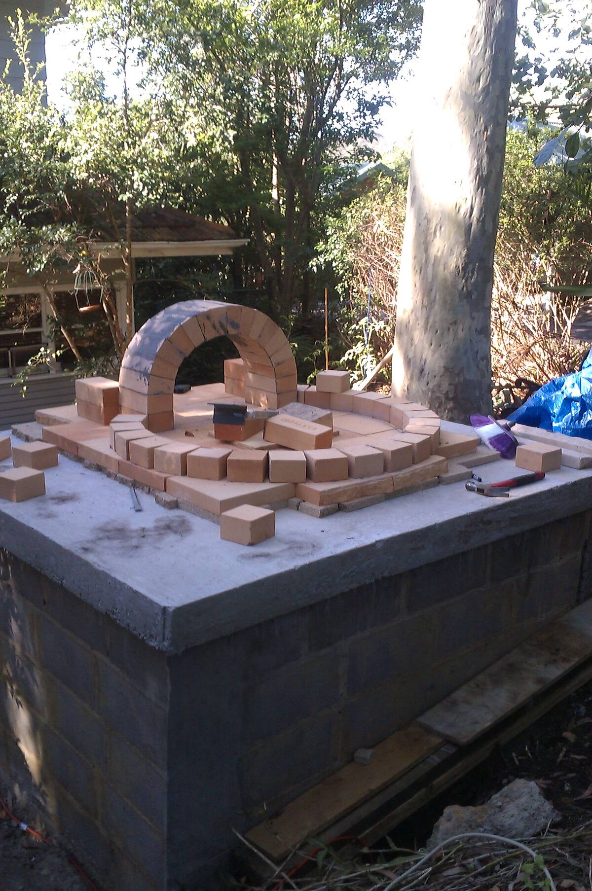 Pizza oven dome taking shape on a block base