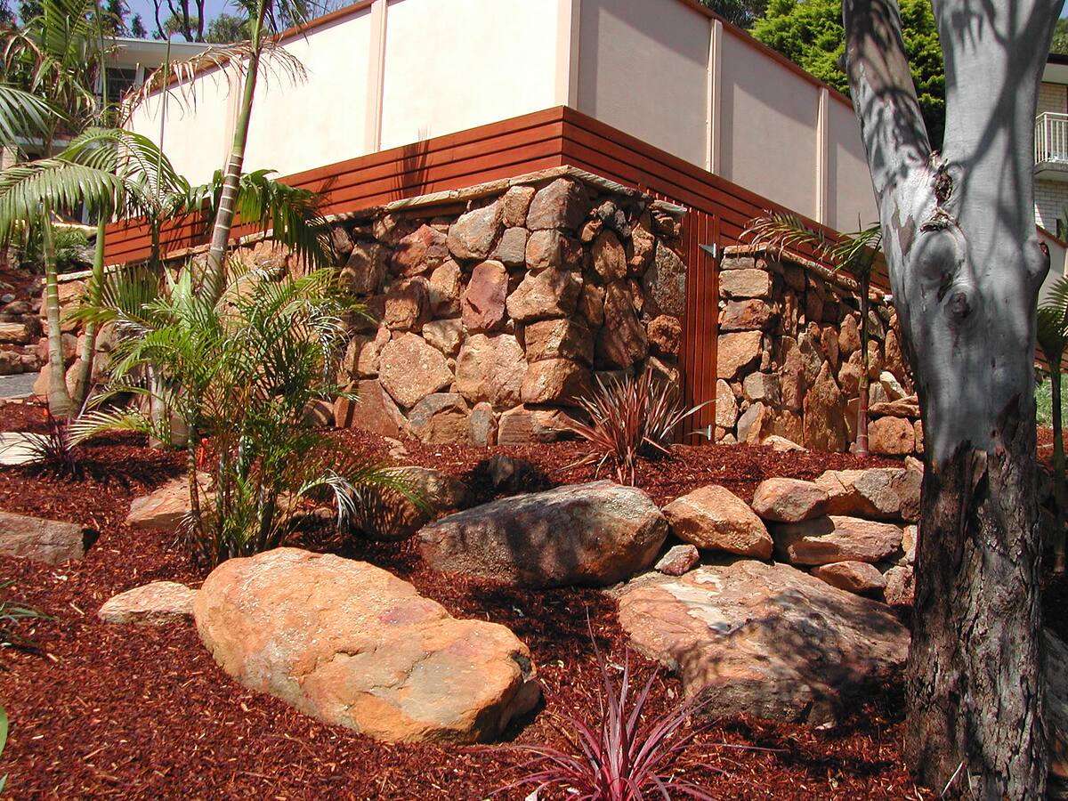 Random-boulder sandstone feature wall built from pool excavation rock in Cromer