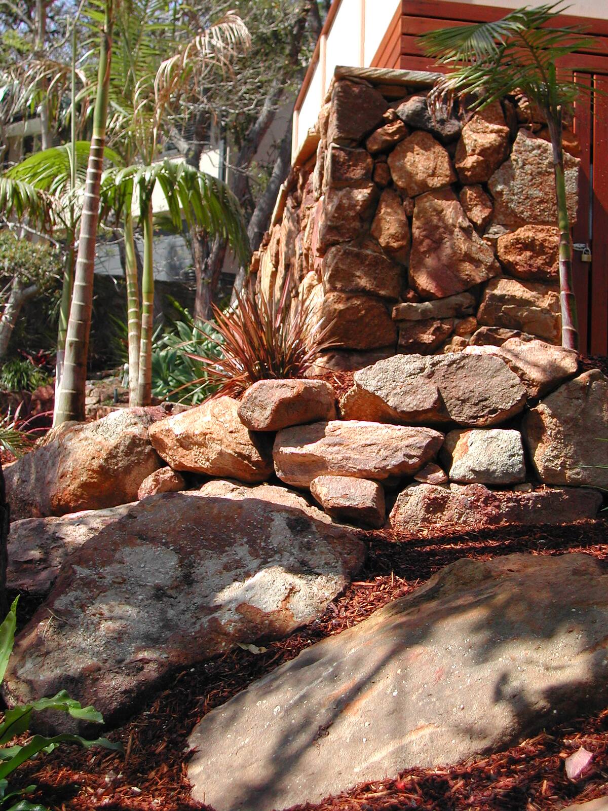 Stacked sandstone boulder pier in a Cromer garden