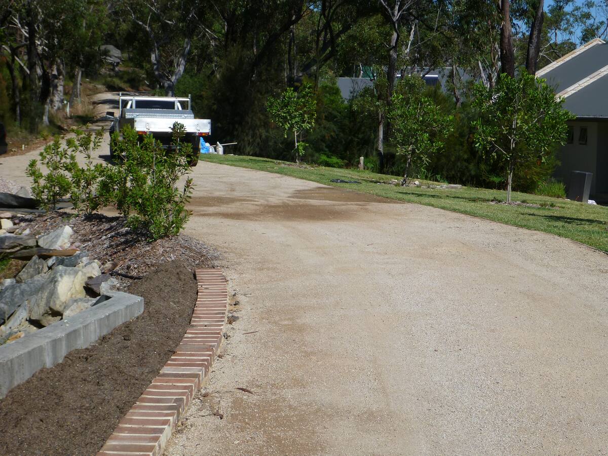 Curved driveway with brick edging and retaining on an acreage