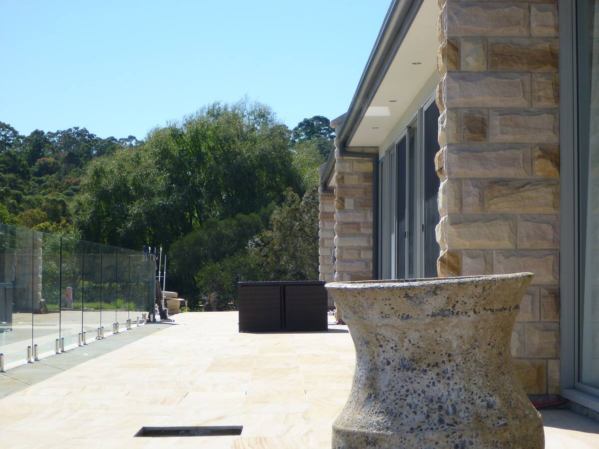Sandstone-paved pool terrace beside sandstone-clad walls, Duffys Forest