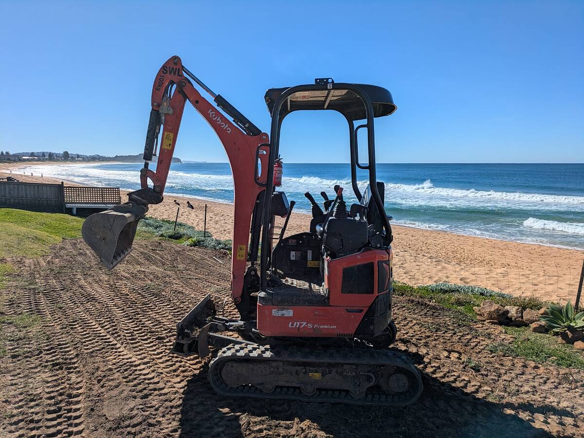 northern beaches landscapers' Kubota mini excavator preparing a beachfront lawn on the Northern Beaches