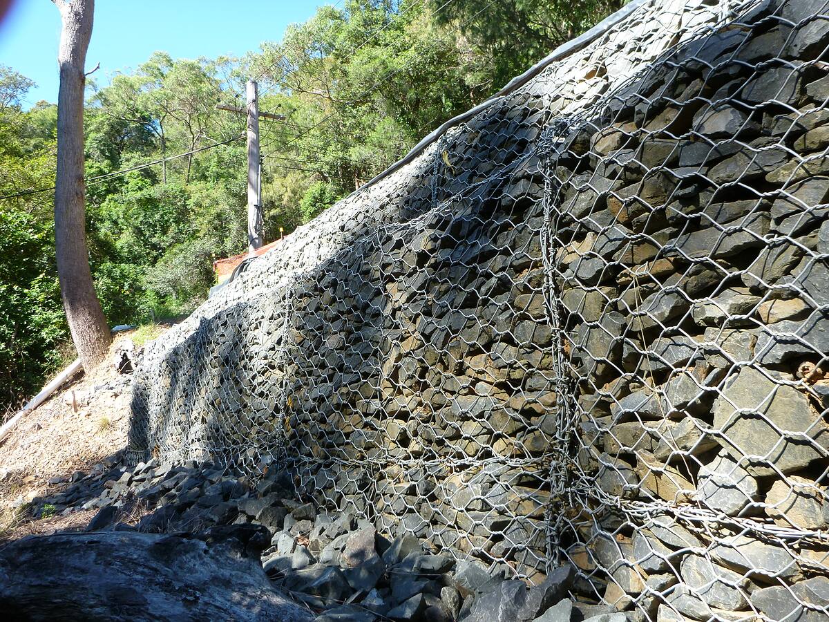Tall gabion rock retaining wall on a steep Northern Beaches block