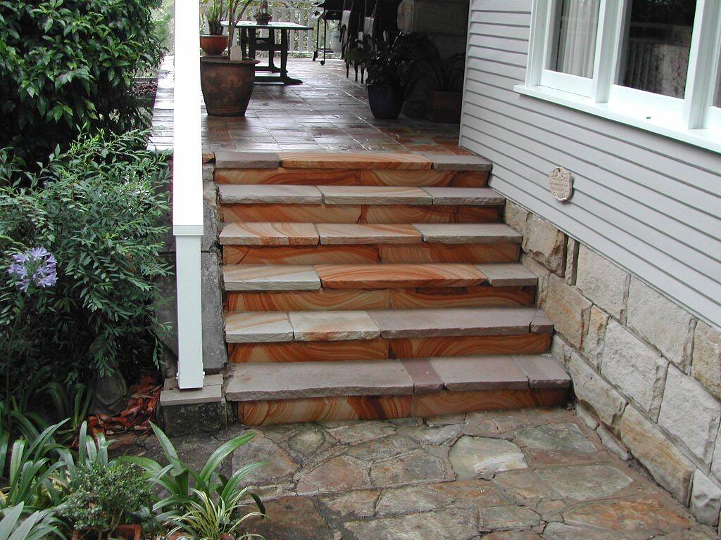 Sandstone stairs leading up to a house entry