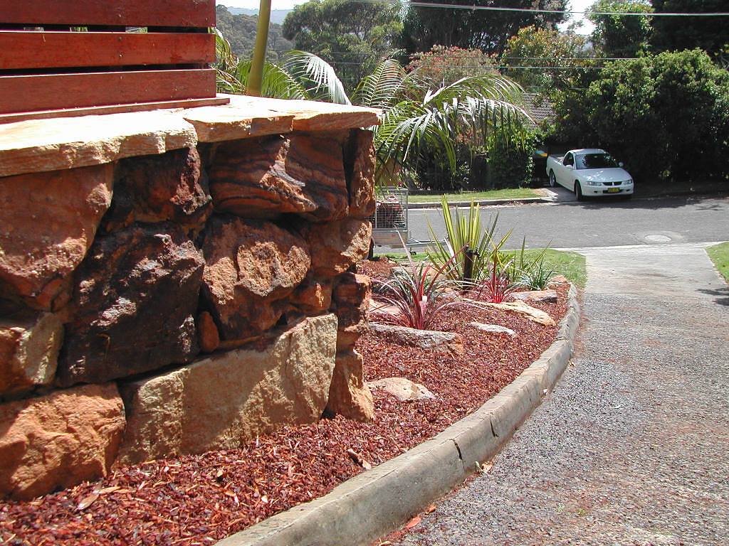 Sandstone boulder wall with garden bed