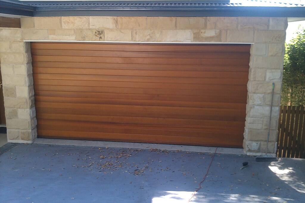 Sandstone cladding around a timber garage door